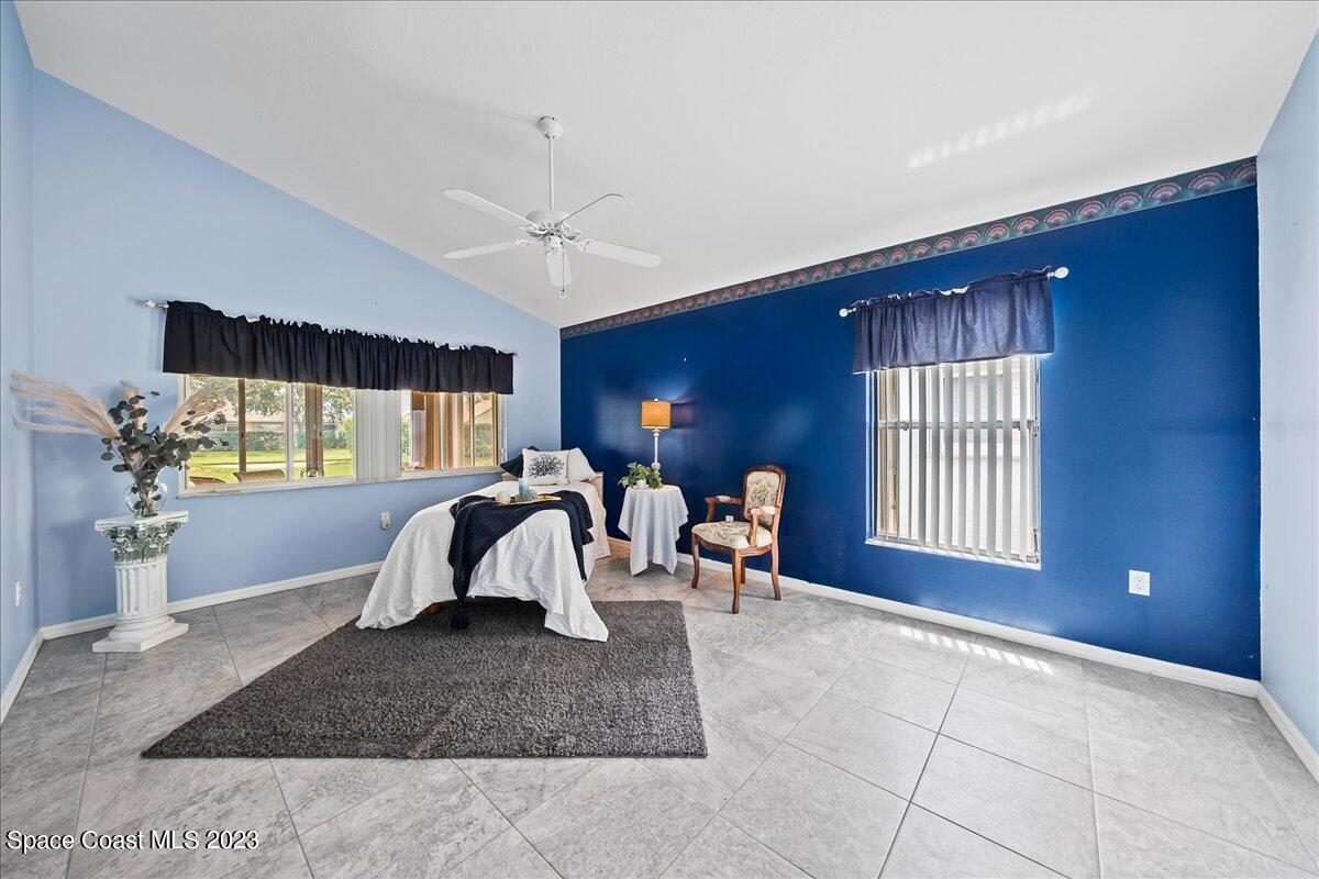1643 Keys Gate Drive Melbourne, FL 32940 - Photo 17 of 43 a living room with furniture a window and a flat screen tv