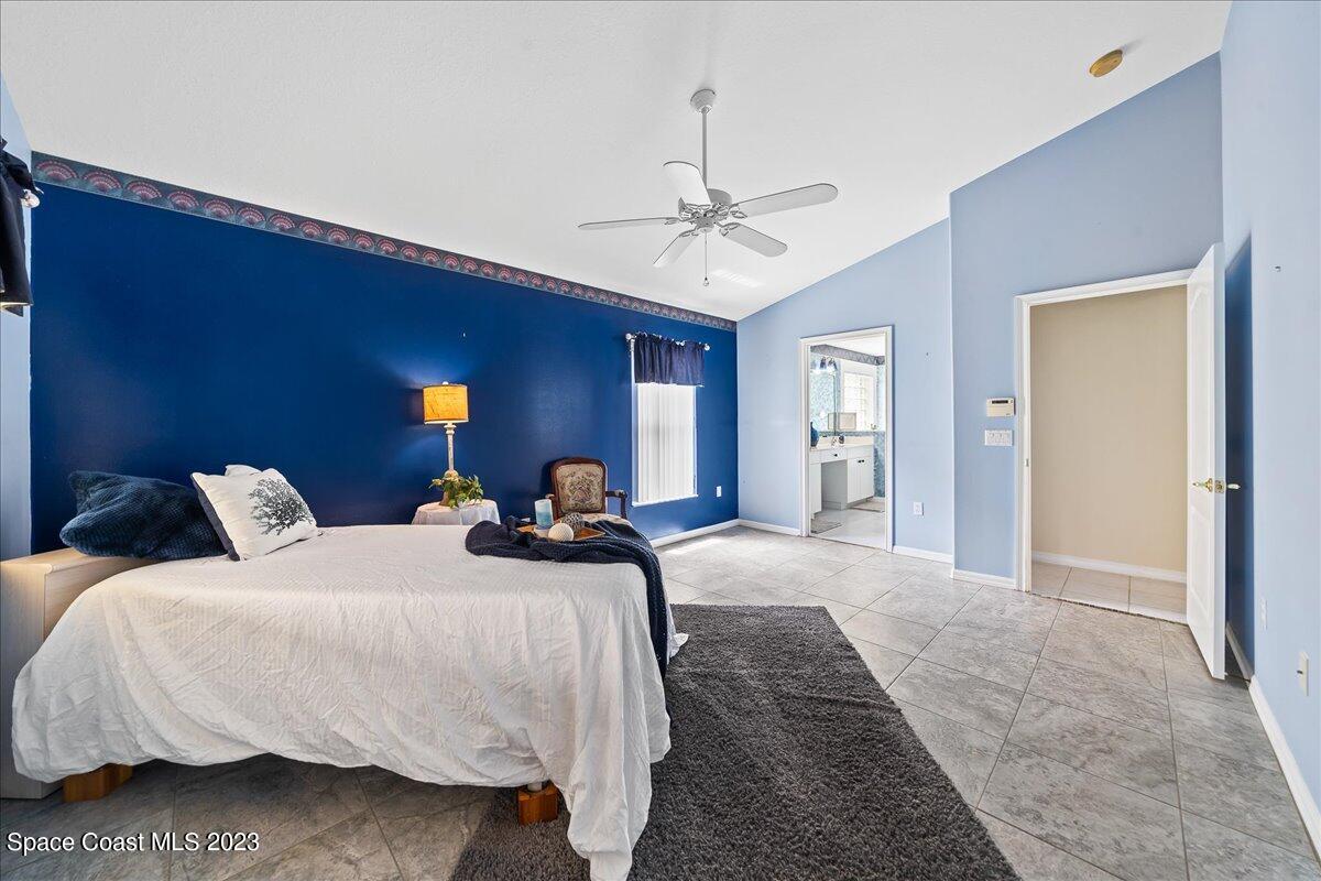 1643 Keys Gate Drive Melbourne, FL 32940 - Photo 18 of 43 a bedroom with bed and window