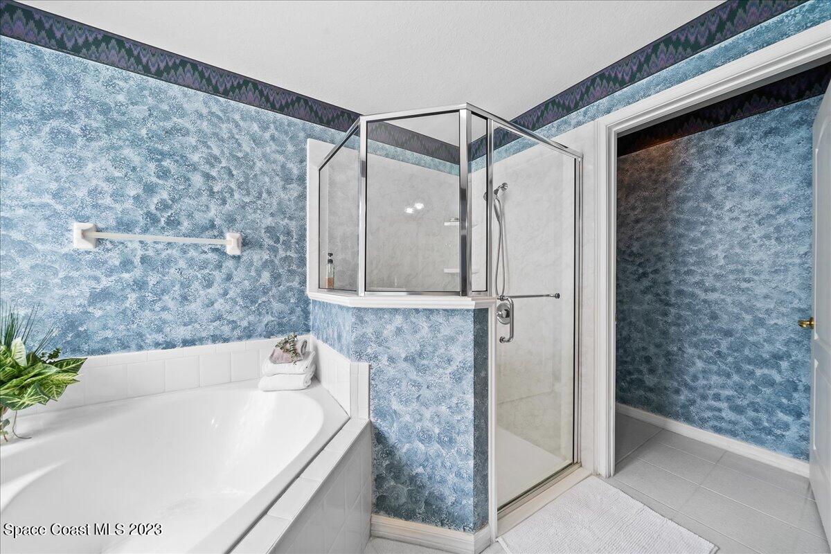 1643 Keys Gate Drive Melbourne, FL 32940 - Photo 21 of 43 a bathroom with a bathtub and a shower