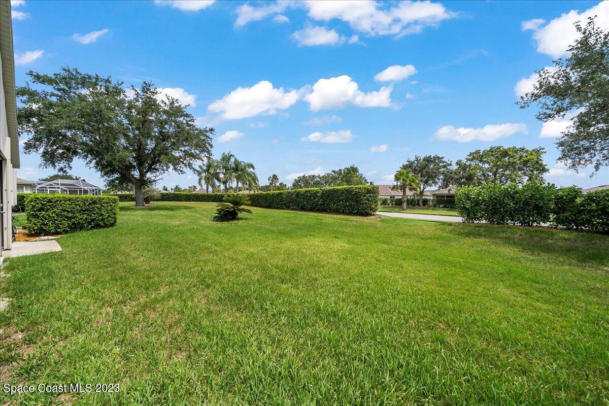 1643 Keys Gate Drive Melbourne, FL 32940 - Photo 33 of 43 a big yard with lots of green space and palm trees