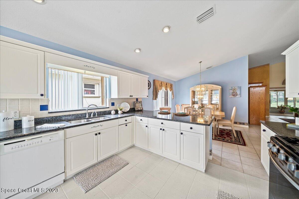 1643 Keys Gate Drive Melbourne, FL 32940 - Photo 10 of 43 a large white kitchen with cabinets a sink and appliances