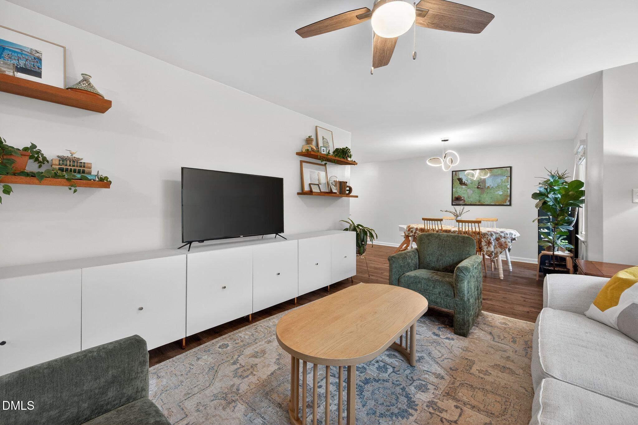 5620 Old Forge Circle Raleigh, NC 27609 - Photo 15 of 46 a living room with furniture and a flat screen tv