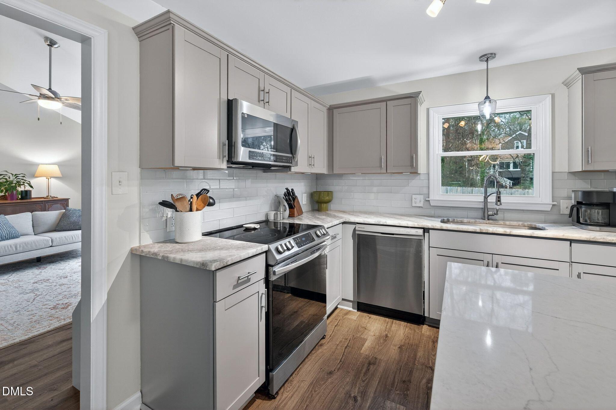 5620 Old Forge Circle Raleigh, NC 27609 - Photo 23 of 46 a kitchen with stainless steel appliances granite countertop a sink stove and microwave