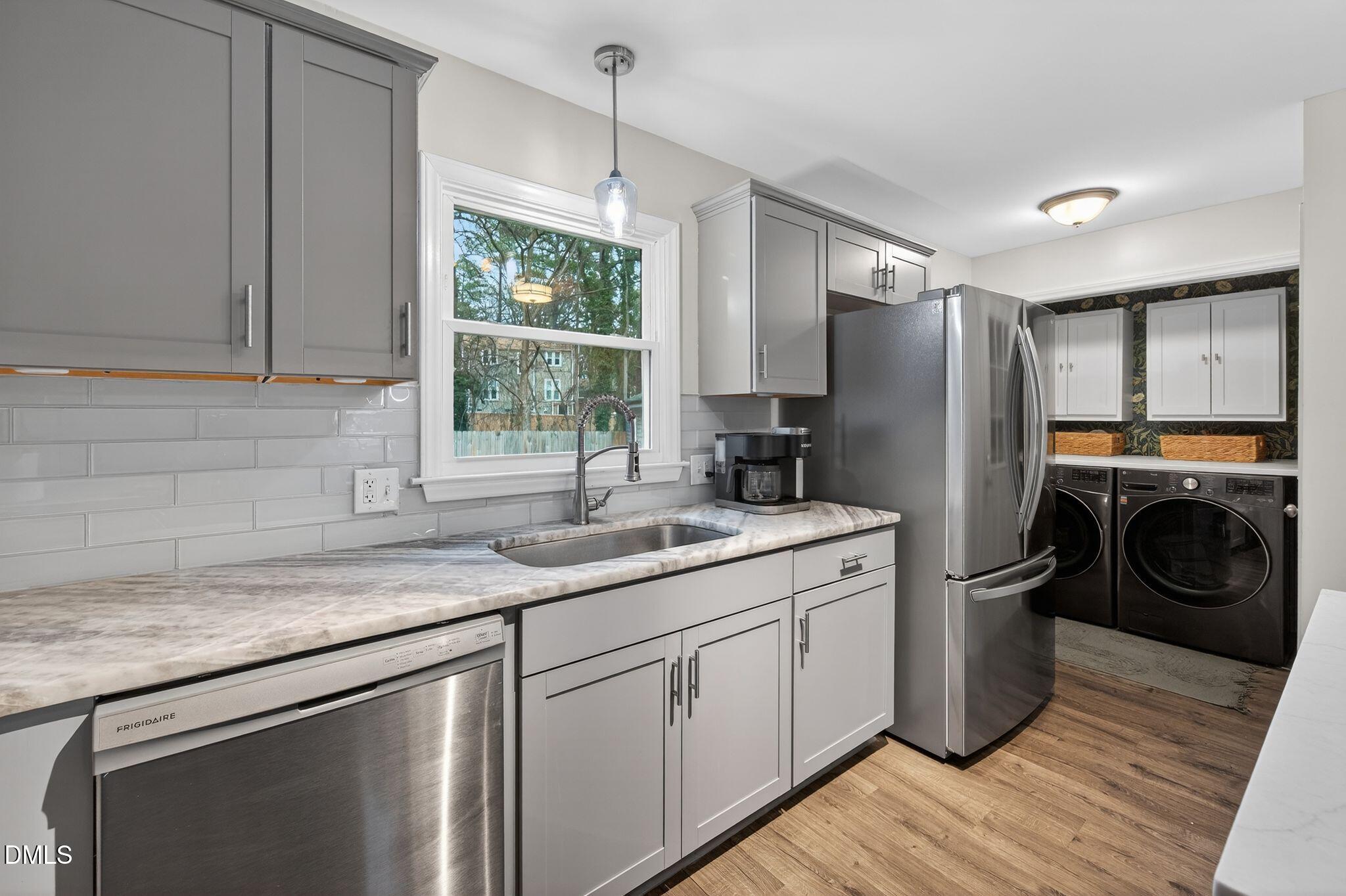 5620 Old Forge Circle Raleigh, NC 27609 - Photo 24 of 46 a kitchen with a sink cabinets and washer