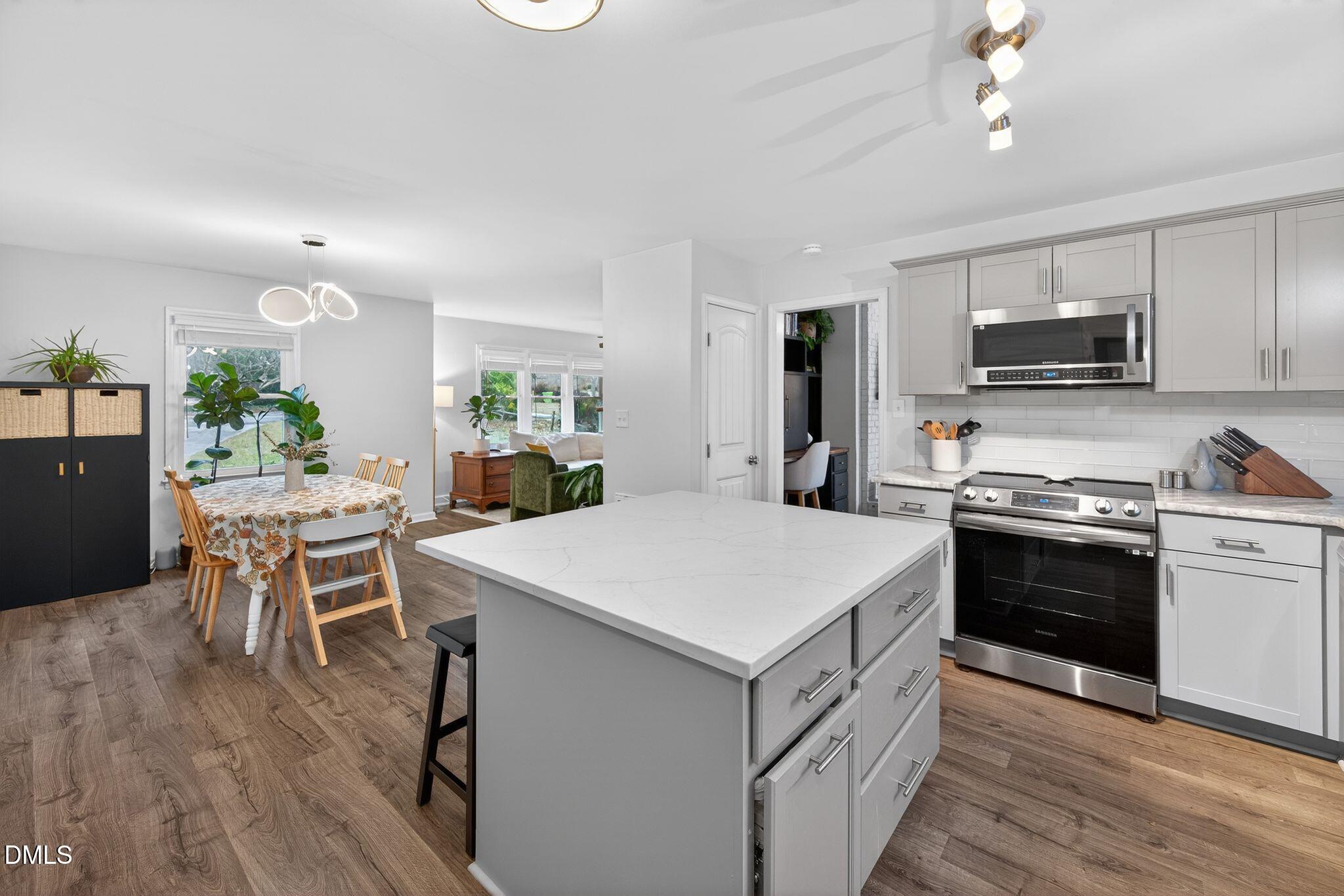 5620 Old Forge Circle Raleigh, NC 27609 - Photo 26 of 46 a kitchen that has a table and chairs in it
