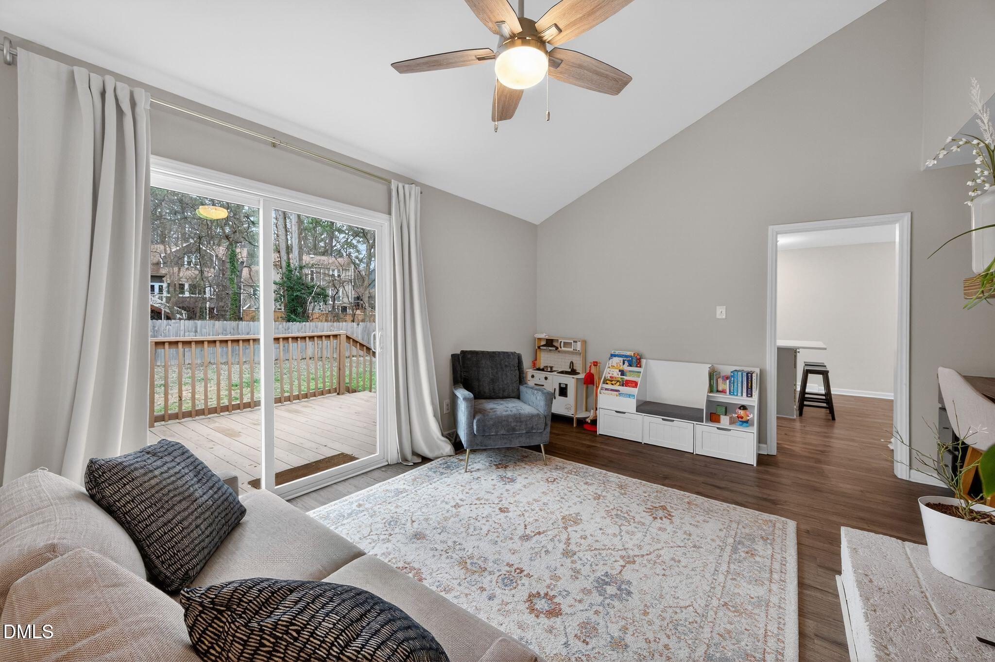 5620 Old Forge Circle Raleigh, NC 27609 - Photo 28 of 46 a living room with furniture and a floor to ceiling window