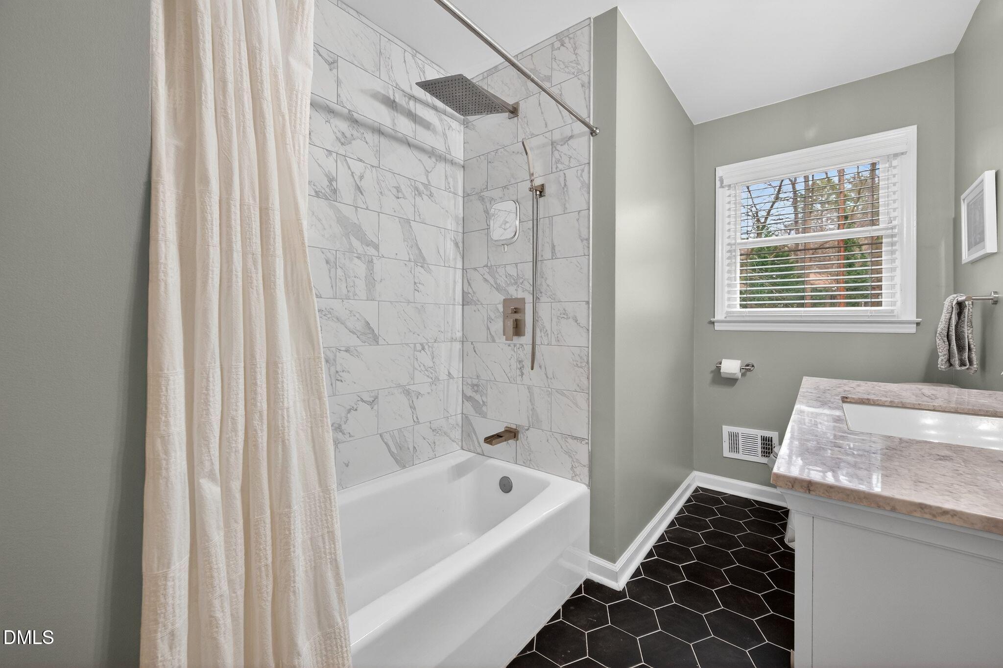 5620 Old Forge Circle Raleigh, NC 27609 - Photo 32 of 46 a bathroom with a granite countertop bathtub shower sink and toilet