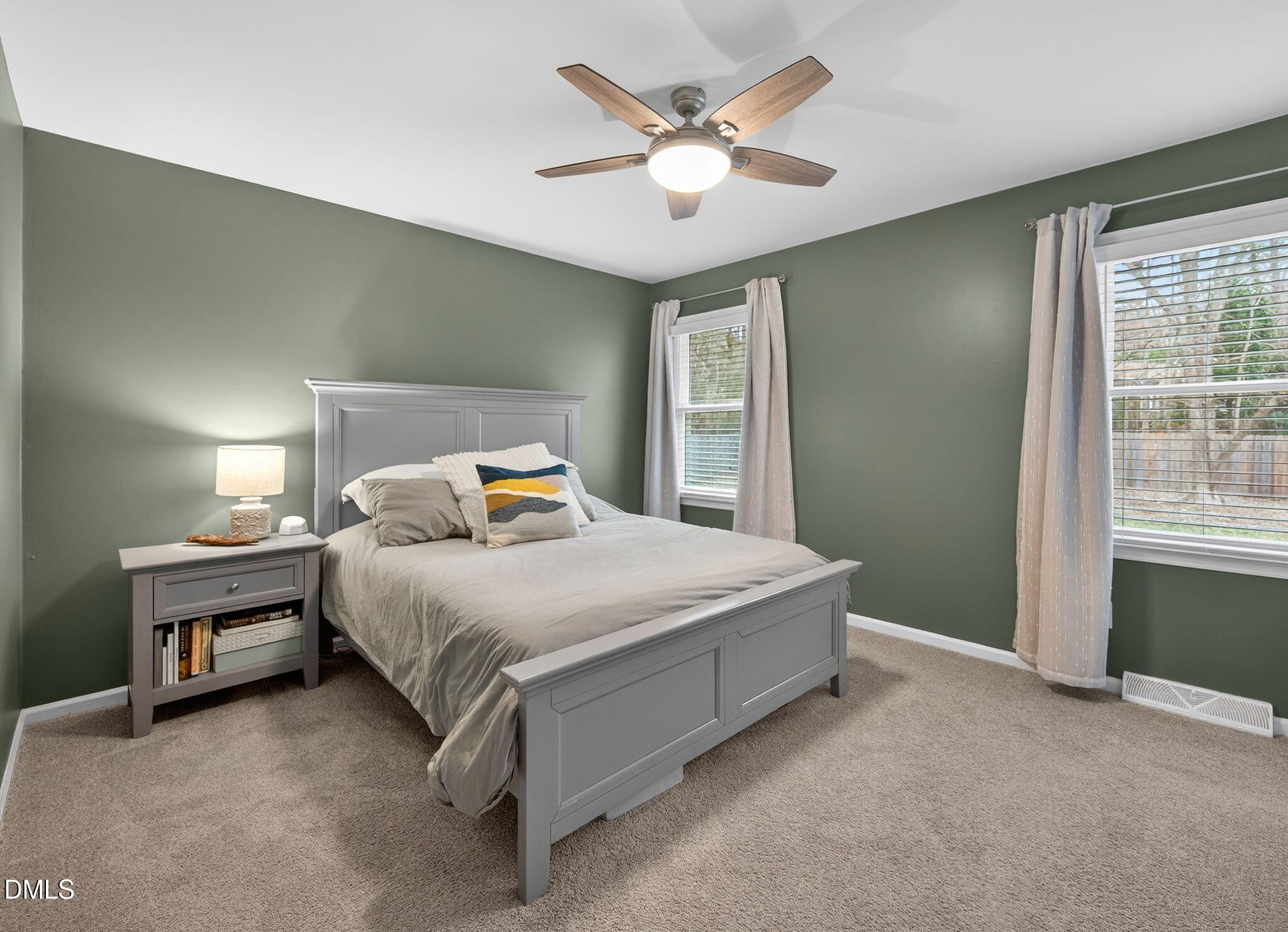 5620 Old Forge Circle Raleigh, NC 27609 - Photo 33 of 46 a bedroom with a bed and a ceiling fan