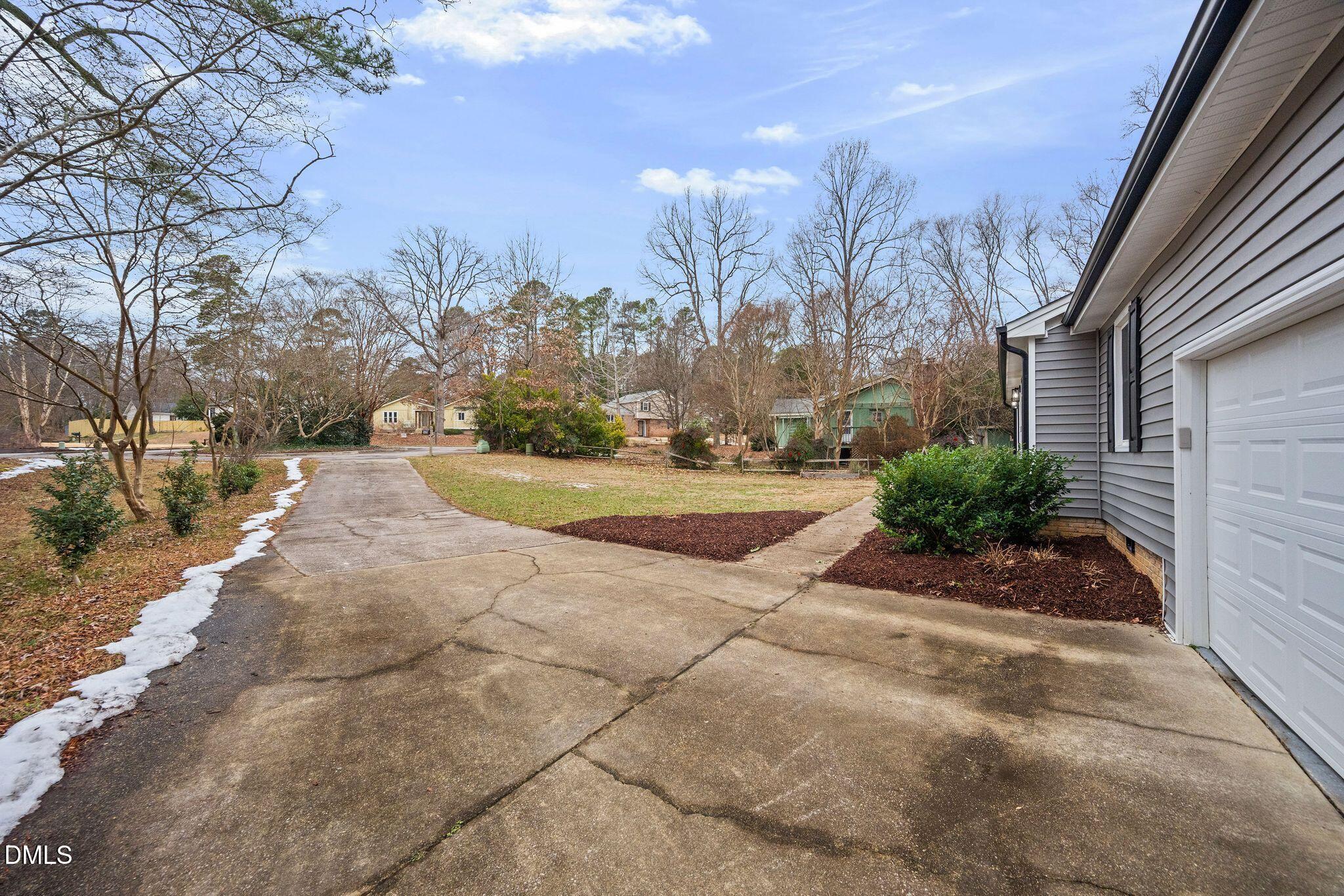 5620 Old Forge Circle Raleigh, NC 27609 - Photo 4 of 46 a view of a yard with plants and trees