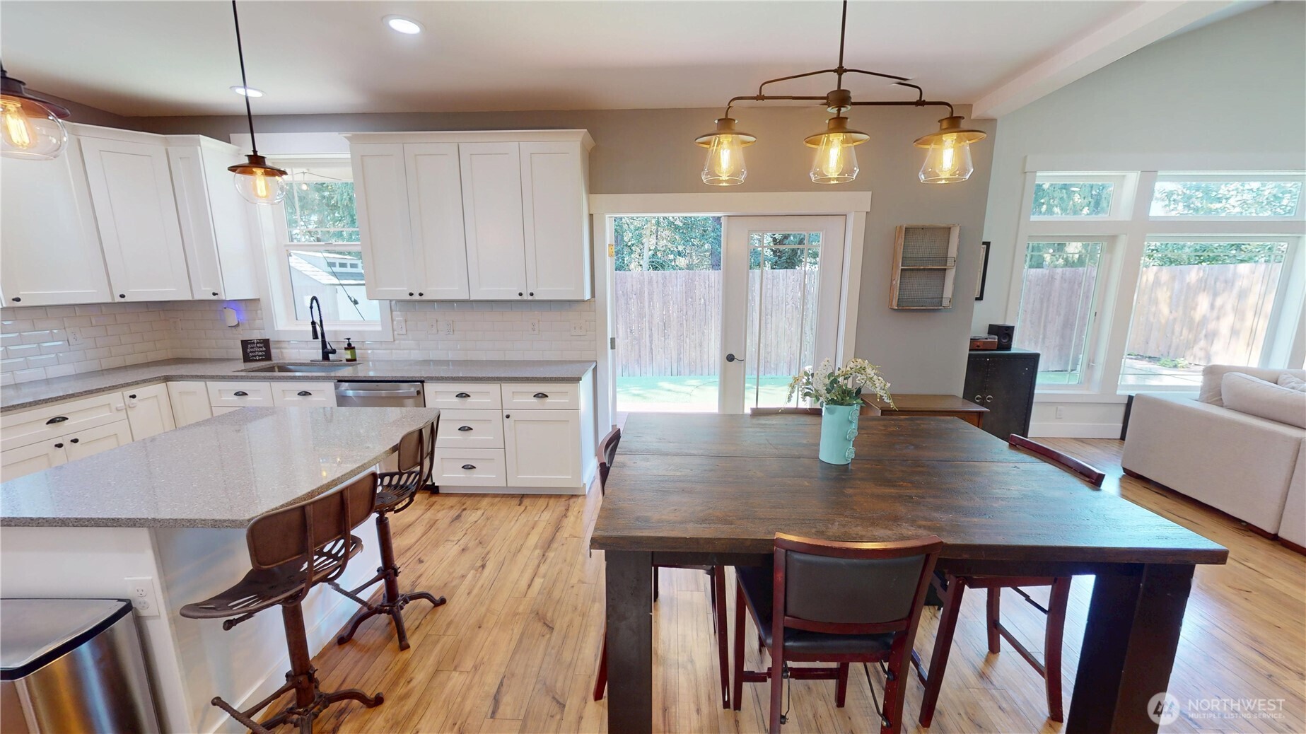 116 Alameda Avenue Fircrest, WA 98466 - Photo 10 of 33 a kitchen with a dining table chairs stainless steel appliances and cabinets