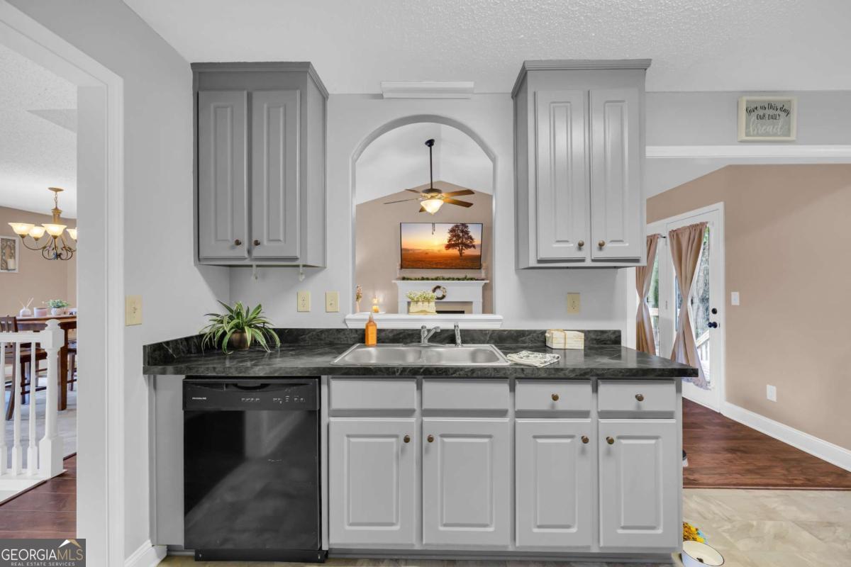 335 Elizabeth Court Colbert, GA 30628 - Photo 12 of 33 a kitchen with granite countertop white cabinets and a stove