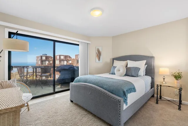 a large bedroom with bed and window