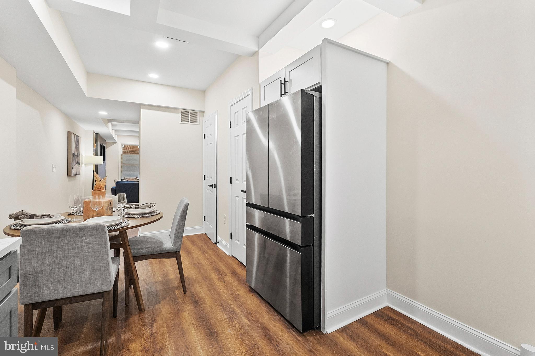 323 South Stricker Street Baltimore, MD 21223 - Photo 11 of 39 a kitchen with stainless steel appliances a refrigerator a table and chairs