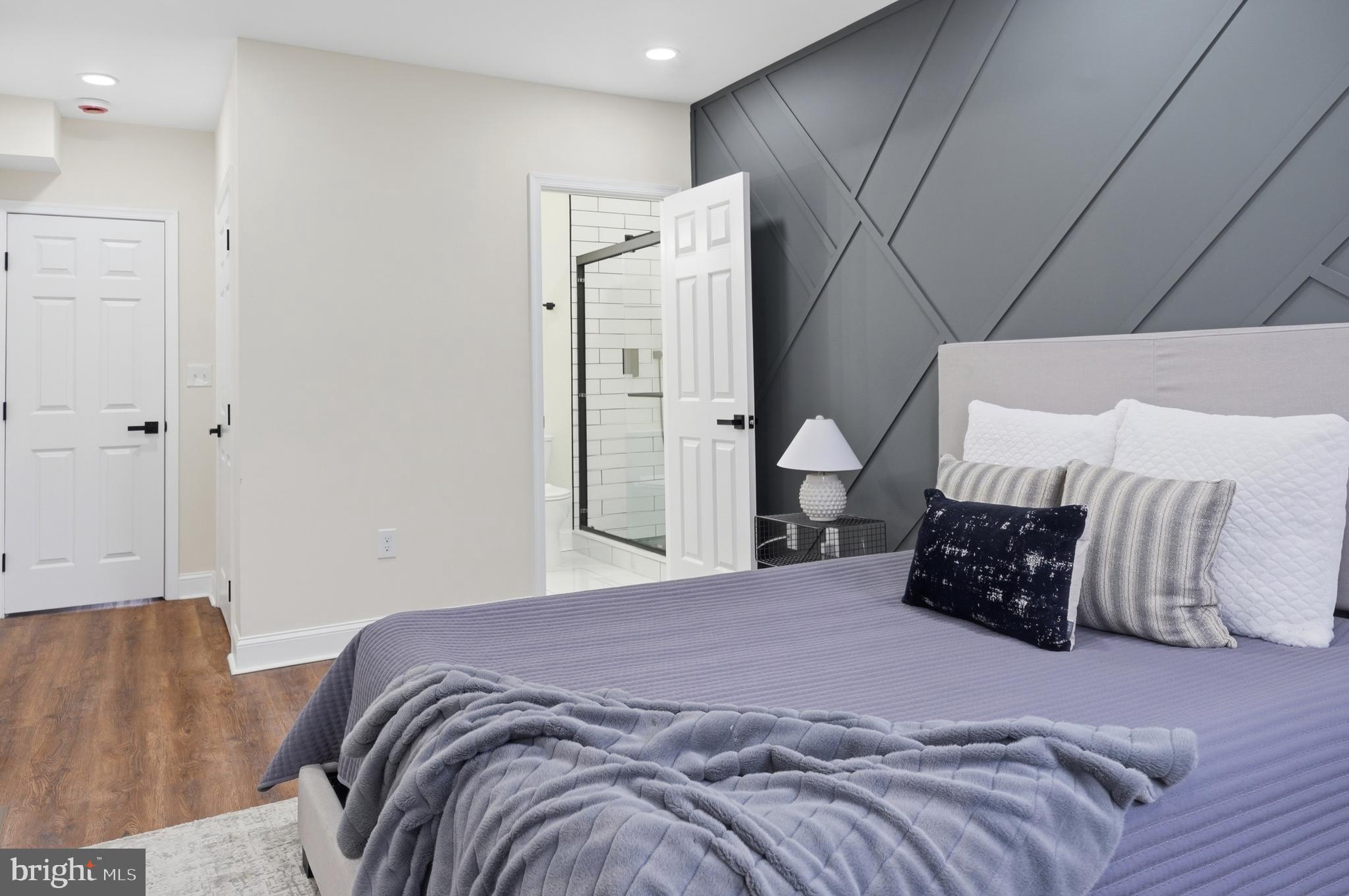 323 South Stricker Street Baltimore, MD 21223 - Photo 13 of 39 a bedroom with a bed painting on wall and a large window