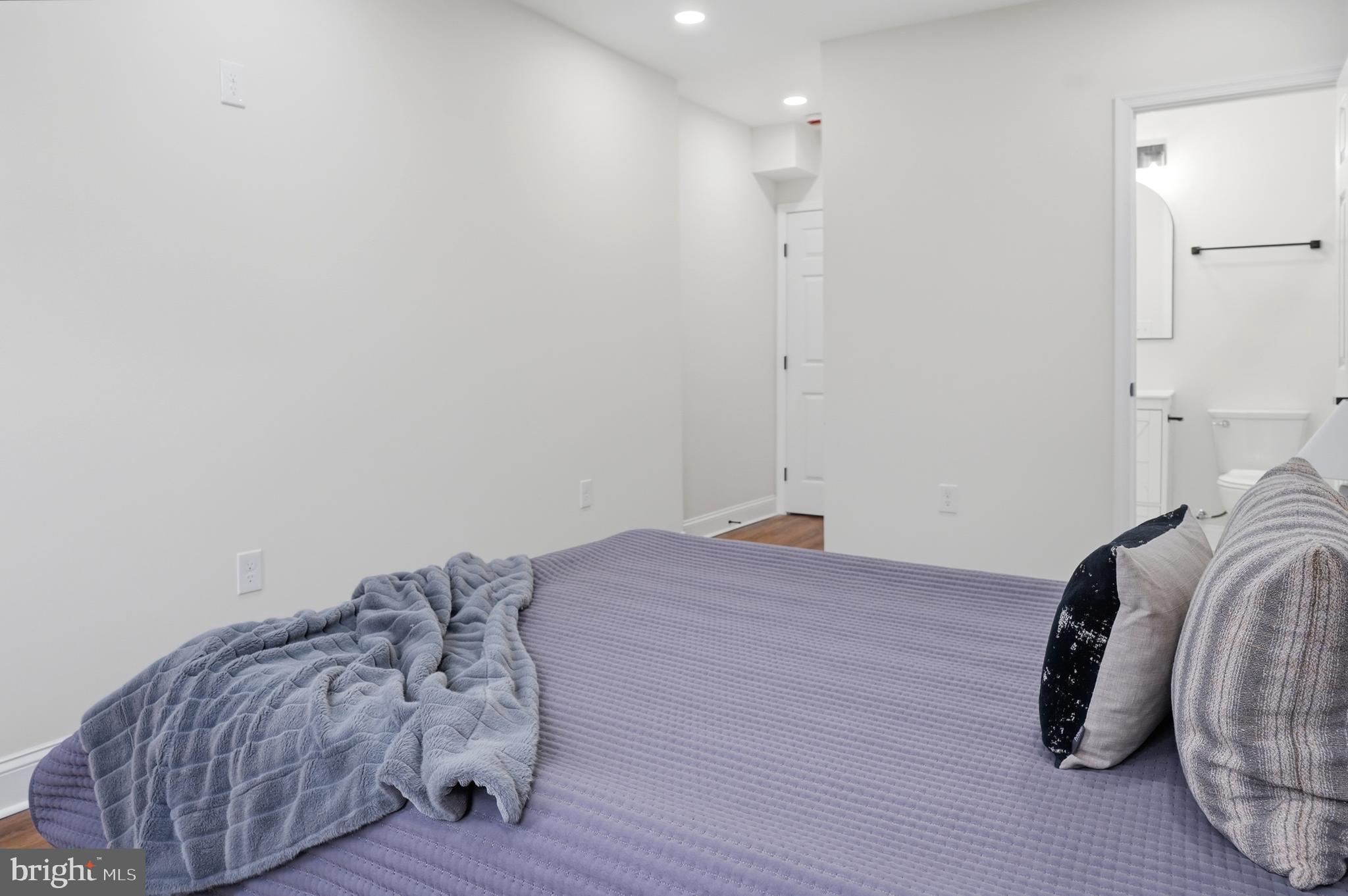 323 South Stricker Street Baltimore, MD 21223 - Photo 14 of 39 a bedroom with a bed and a mirror