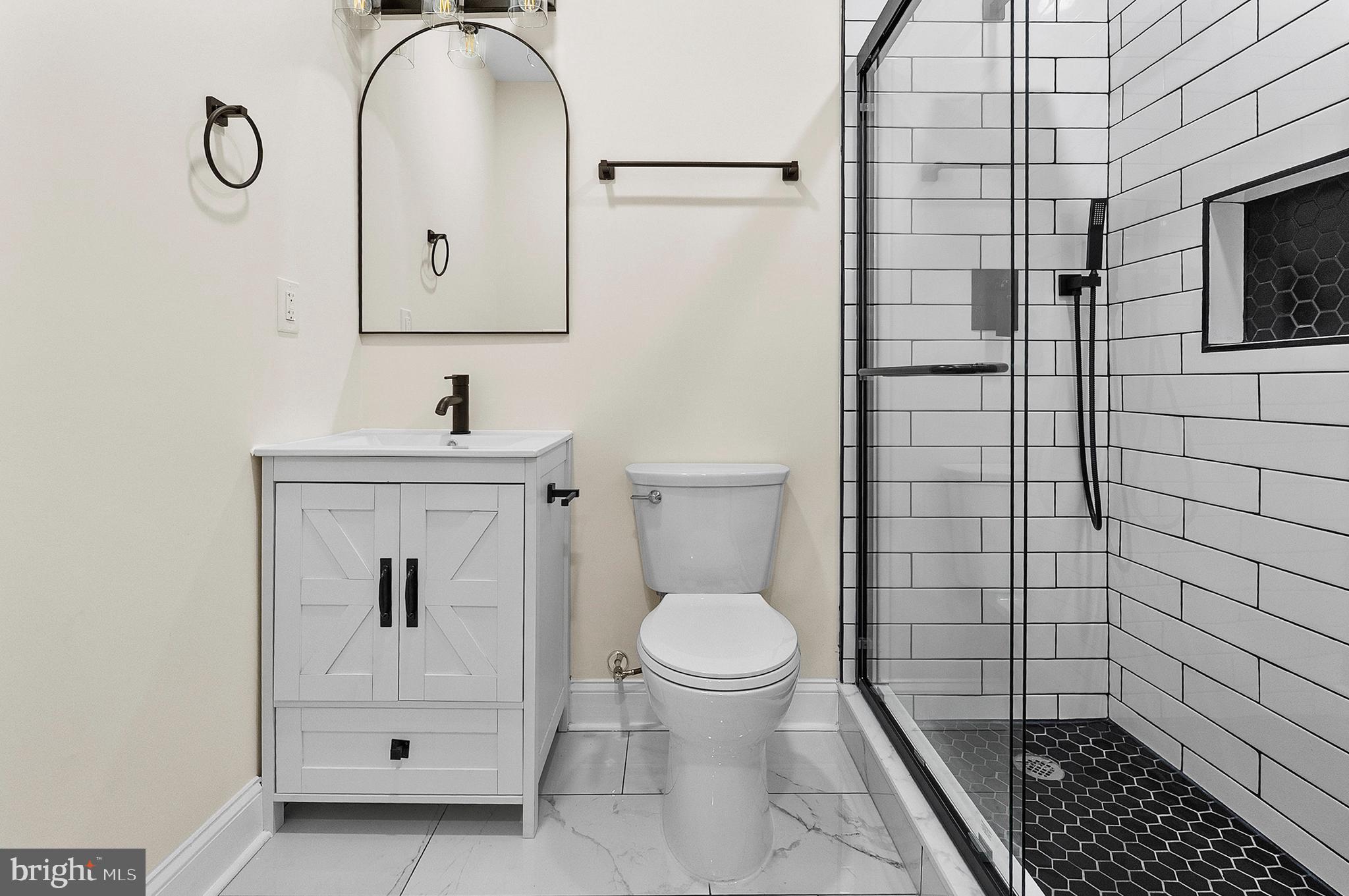 323 South Stricker Street Baltimore, MD 21223 - Photo 16 of 39 a bathroom with a sink toilet and shower