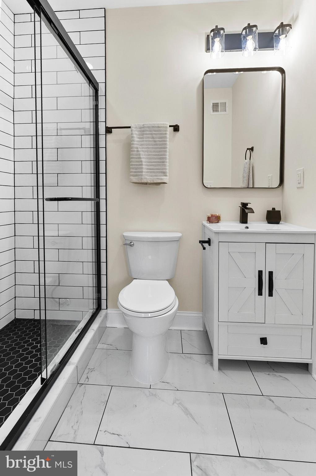 323 South Stricker Street Baltimore, MD 21223 - Photo 17 of 39 a bathroom with a toilet sink vanity and mirror