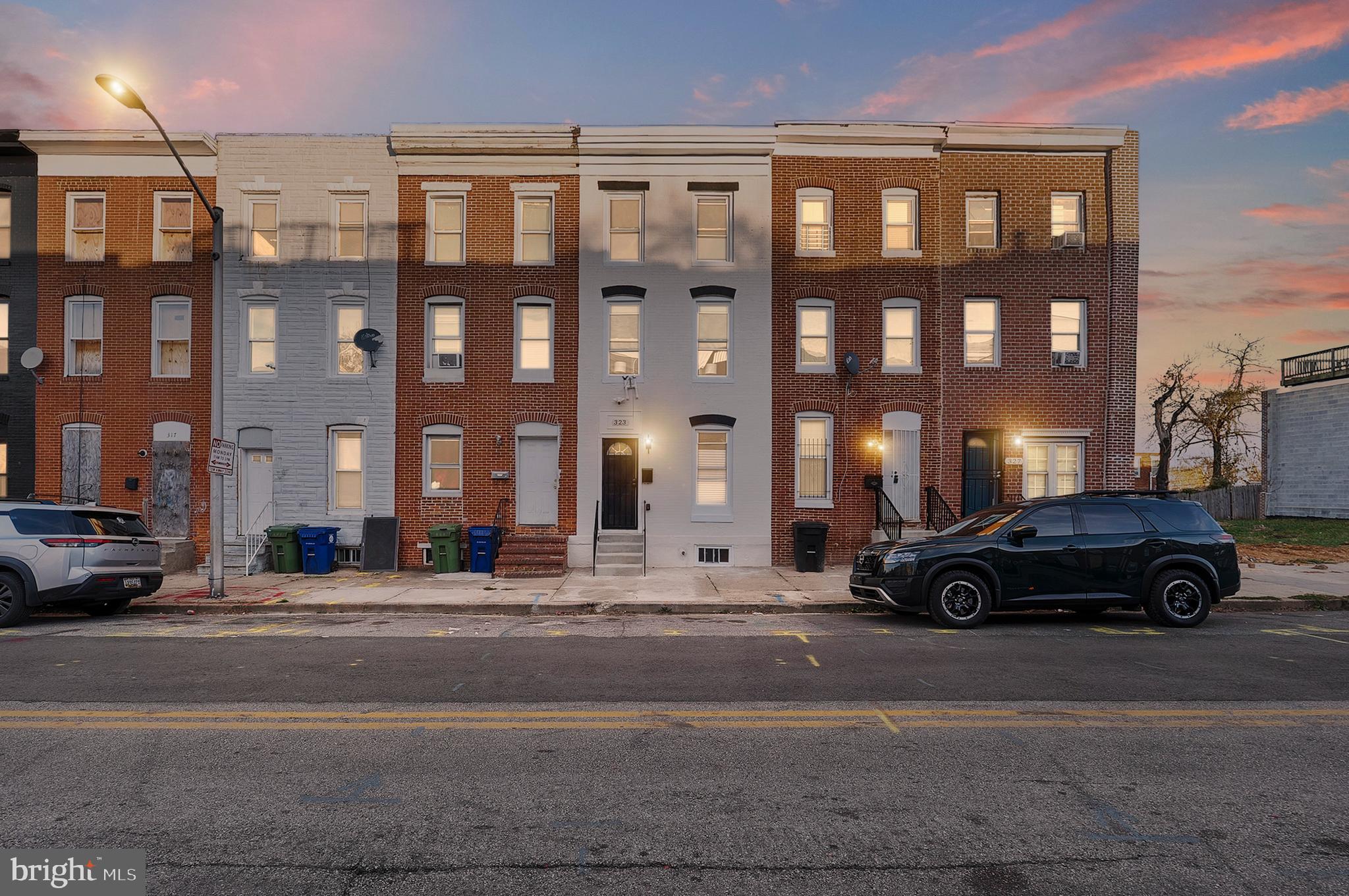 323 South Stricker Street Baltimore, MD 21223 - Photo 2 of 39 a car parked in front of a building