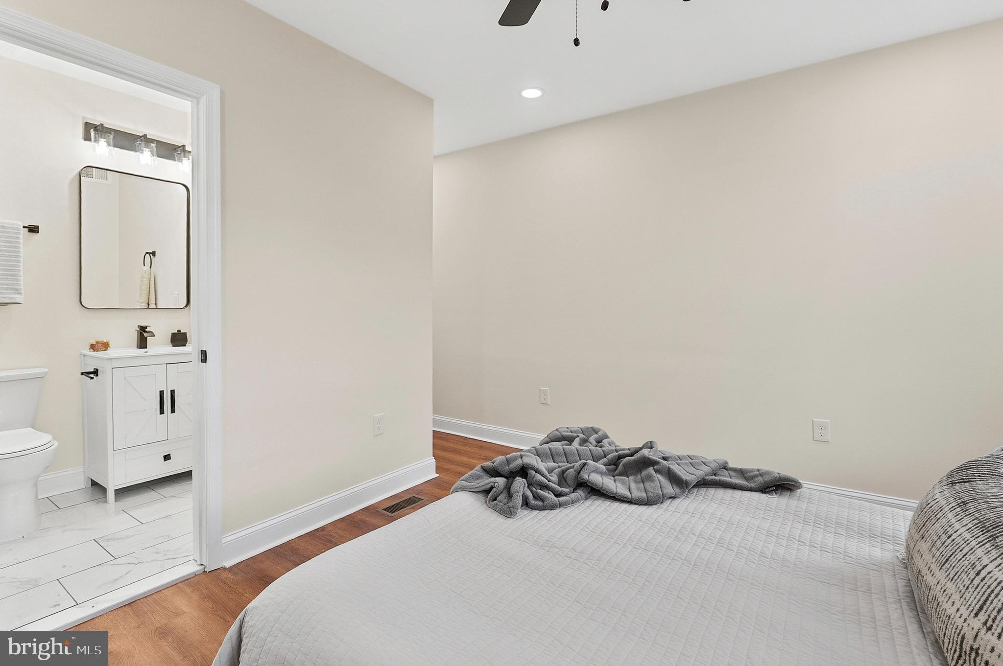 323 South Stricker Street Baltimore, MD 21223 - Photo 22 of 39 a bedroom with a bed and a view of bathroom