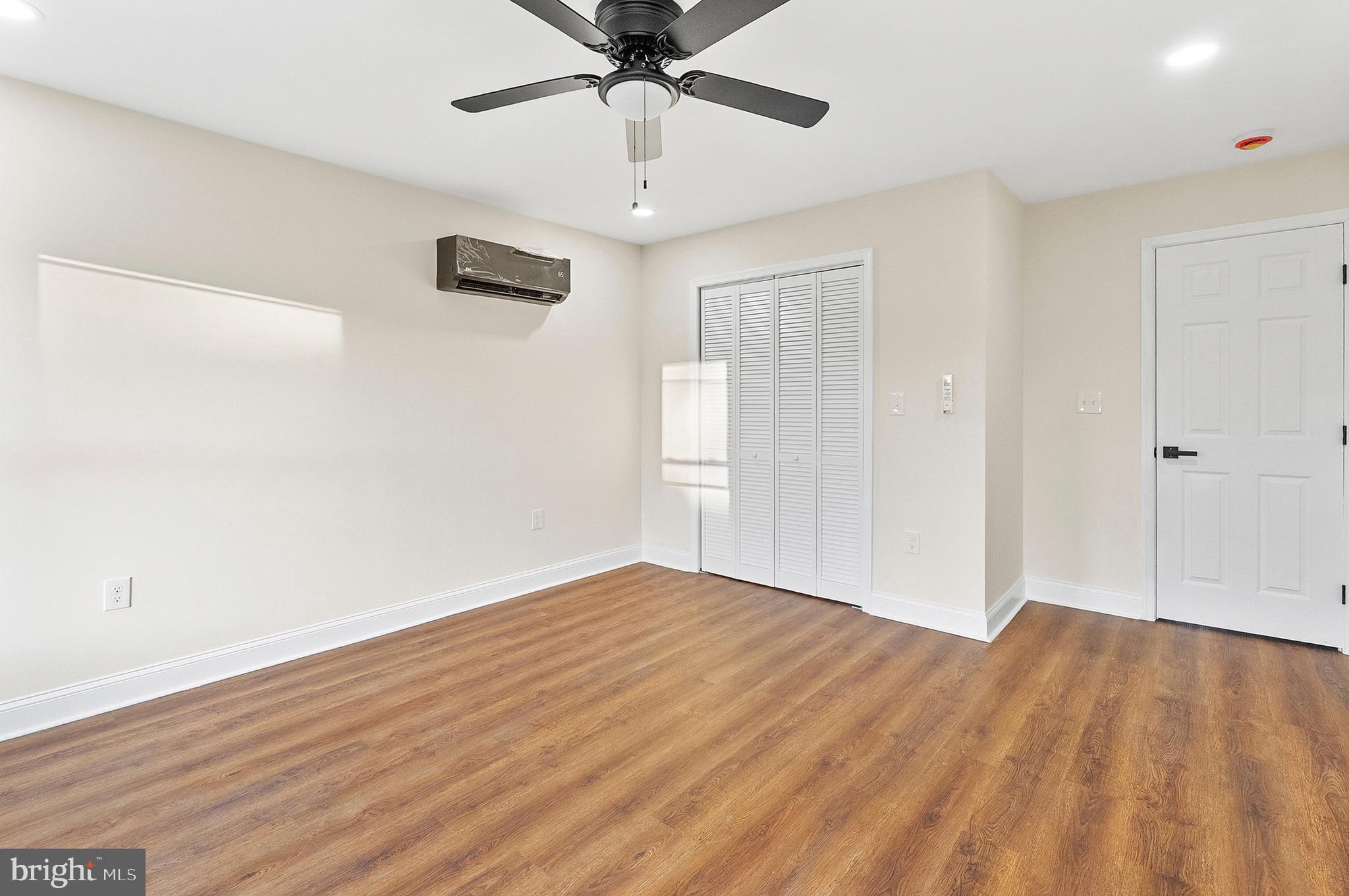 323 South Stricker Street Baltimore, MD 21223 - Photo 25 of 39 a view of empty room with wooden floor and fan