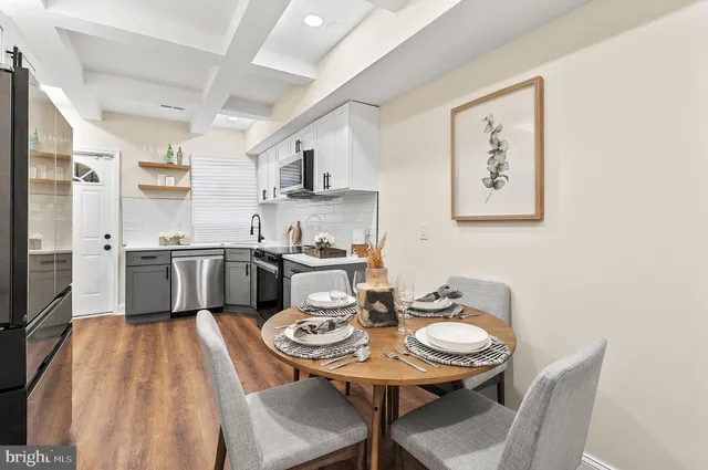 a kitchen with stainless steel appliances a white stove top oven a sink dishwasher and white cabinets
