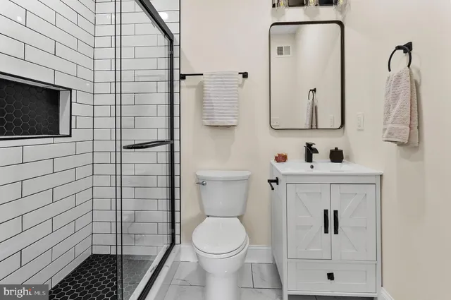 a bathroom with a toilet sink and mirror