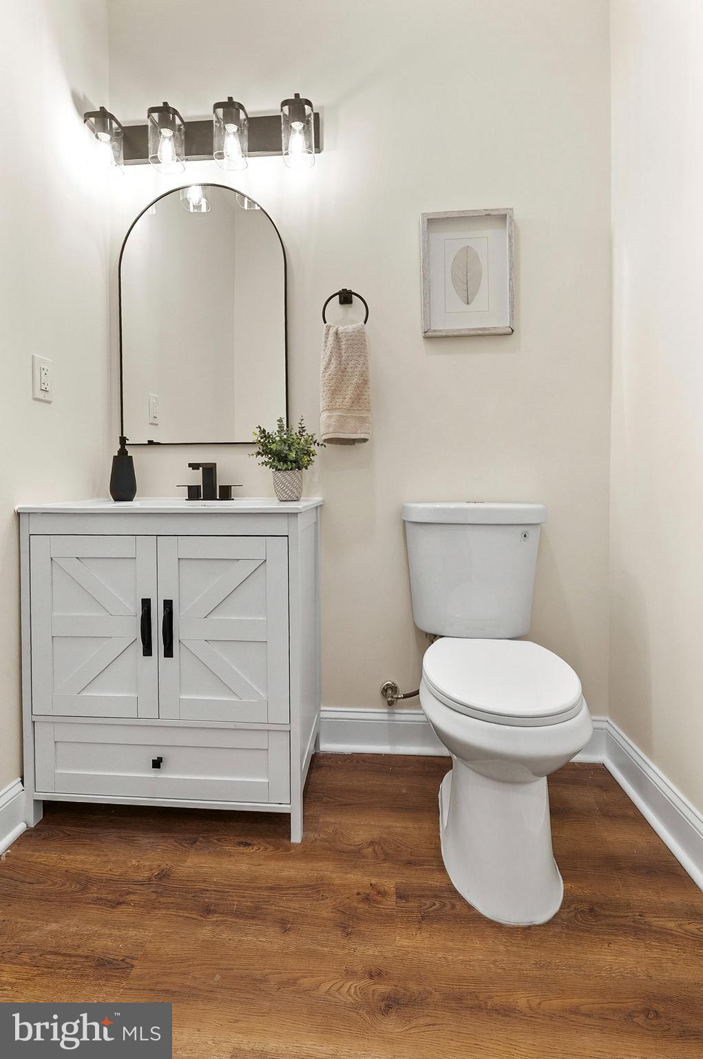323 South Stricker Street Baltimore, MD 21223 - Photo 33 of 39 a bathroom with a toilet sink and mirror