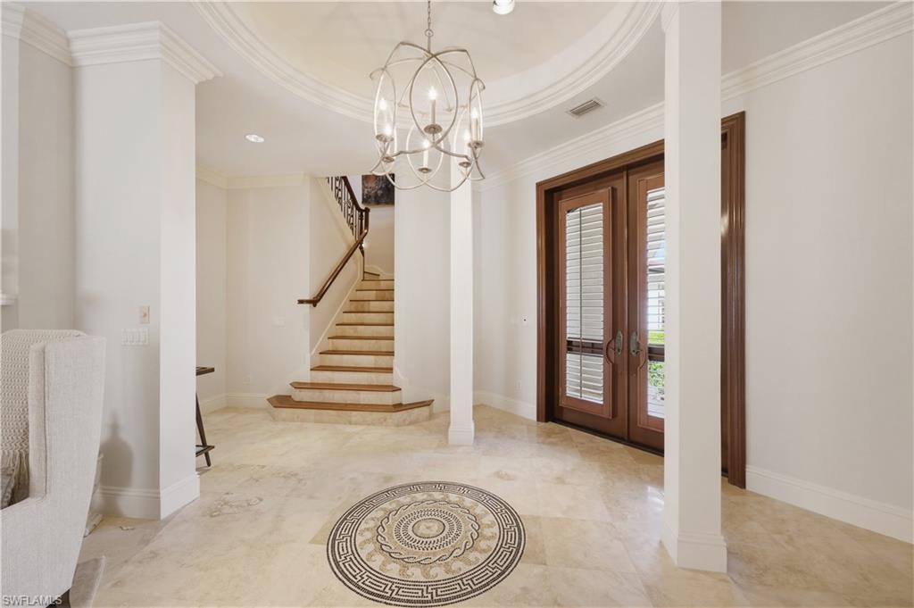 361 Pirates Bight Naples, FL 34103 - Photo 6 of 45 a view of a hallway with wooden floor and staircase