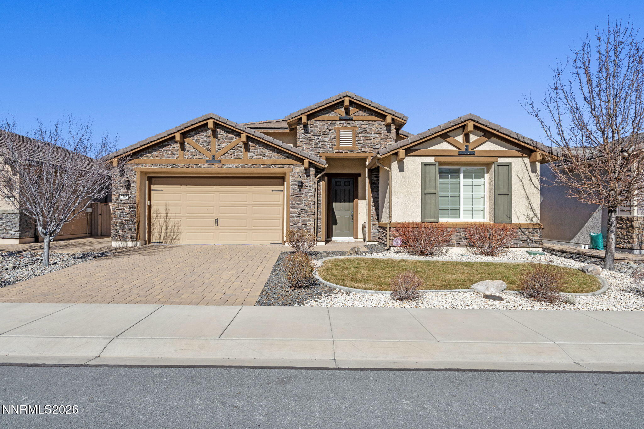 9785 Hafflinger Lane Reno, NV 89521 - Photo 1 of 34 a front view of a house with garden