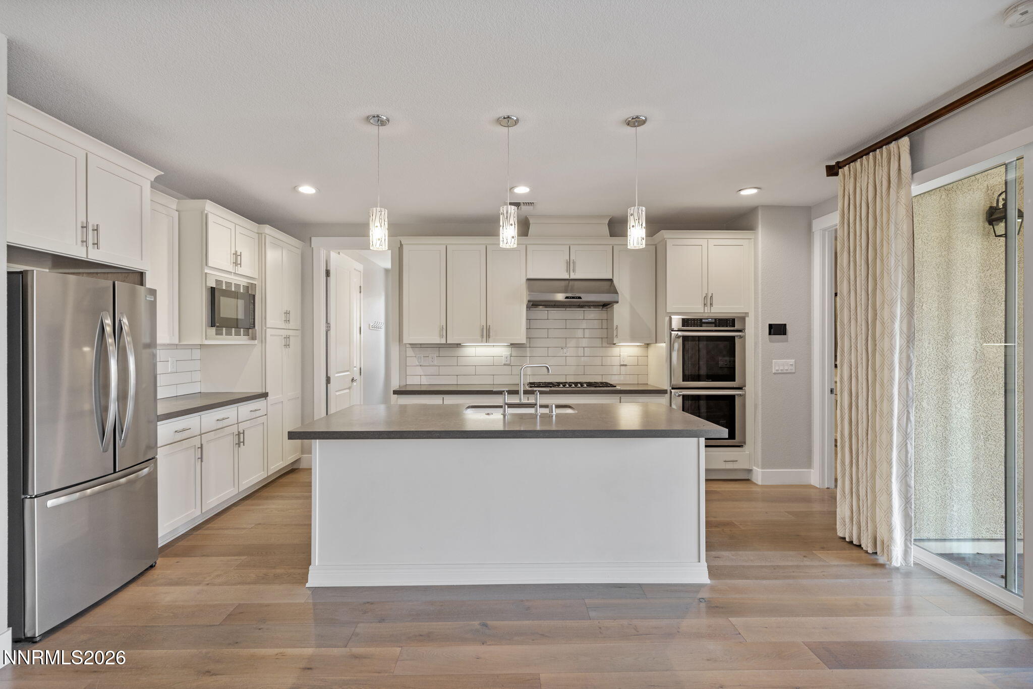 9785 Hafflinger Lane Reno, NV 89521 - Photo 17 of 34 a kitchen with stainless steel appliances granite countertop a refrigerator a stove and a sink