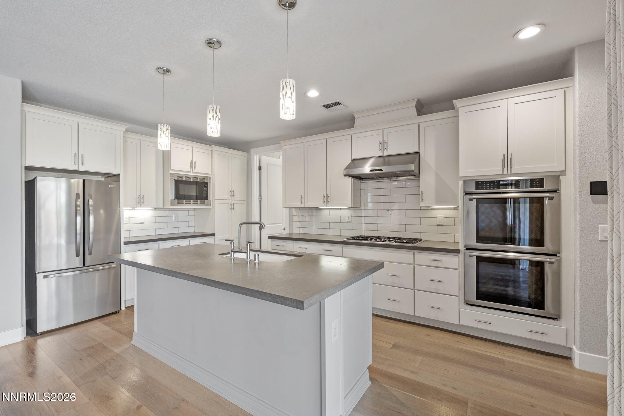9785 Hafflinger Lane Reno, NV 89521 - Photo 18 of 34 a kitchen with stainless steel appliances granite countertop a sink stove and refrigerator