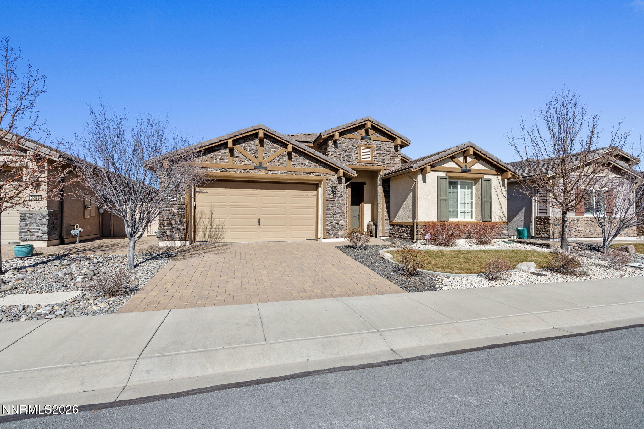 9785 Hafflinger Lane Reno, NV 89521 - Photo 2 of 34 a front view of a house with a yard
