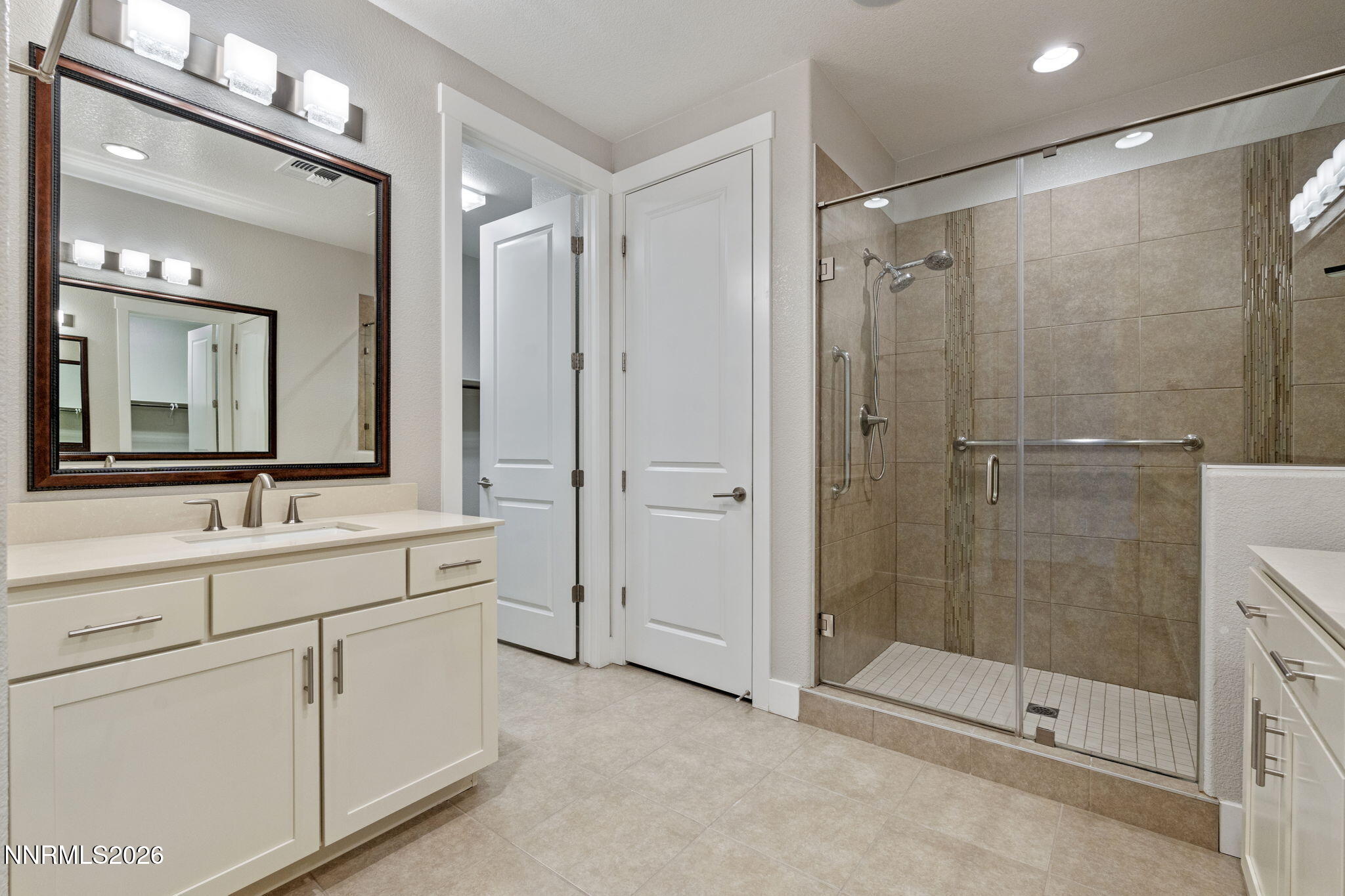 9785 Hafflinger Lane Reno, NV 89521 - Photo 25 of 34 a bathroom with a shower sink and mirror