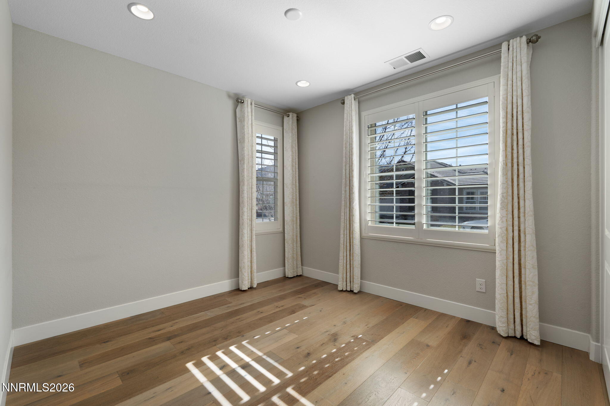 9785 Hafflinger Lane Reno, NV 89521 - Photo 27 of 34 a view of an empty room with wooden floor and a window