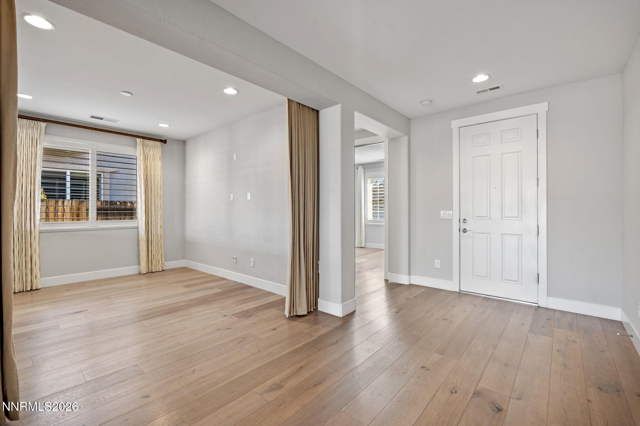 9785 Hafflinger Lane Reno, NV 89521 - Photo 4 of 34 wooden floor in an empty room with a window