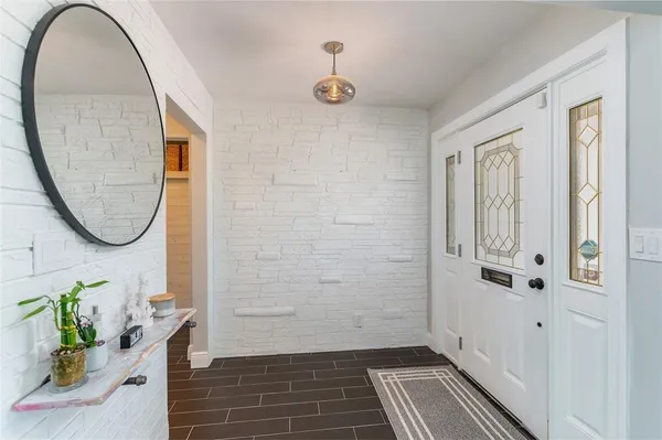 a kitchen with stainless steel appliances kitchen island granite countertop a table chairs and a refrigerator