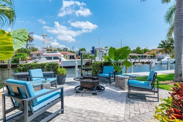 a view of a chairs and table in patio with a fire pit