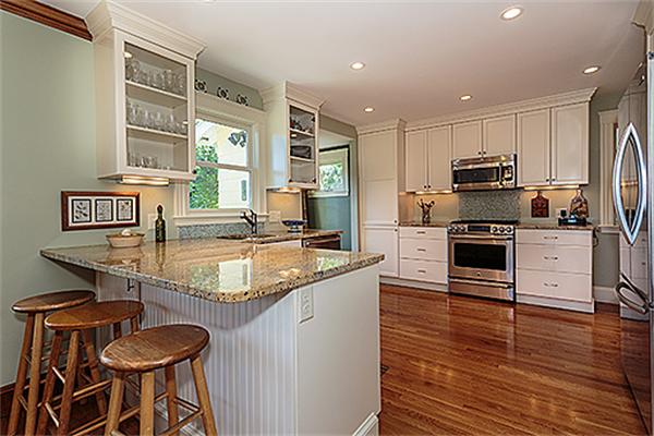 36 Argyle Road Arlington, MA 02476 - Photo 11 of 26 a kitchen with granite countertop kitchen island stainless steel appliances a stove a sink and a refrigerator