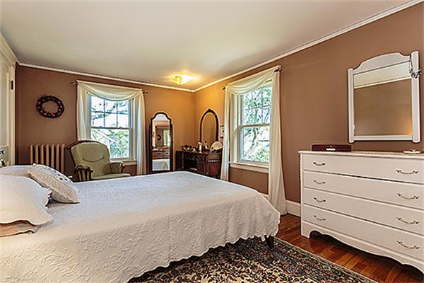 36 Argyle Road Arlington, MA 02476 - Photo 16 of 26 a bedroom with a bed and a dresser next to a window