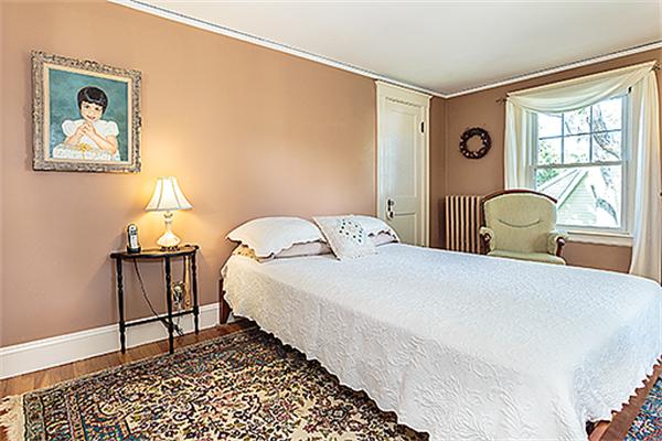 36 Argyle Road Arlington, MA 02476 - Photo 17 of 26 a bedroom with a bed a table and painting on the wall