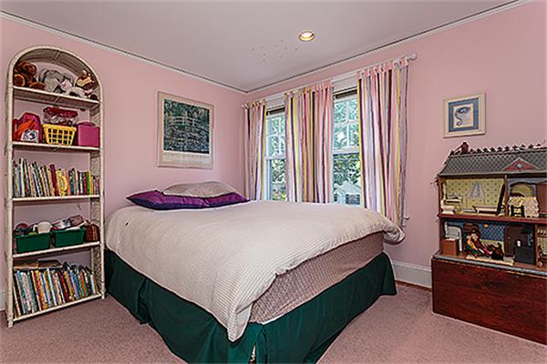 36 Argyle Road Arlington, MA 02476 - Photo 18 of 26 a bed sitting in a bedroom next to a book shelf