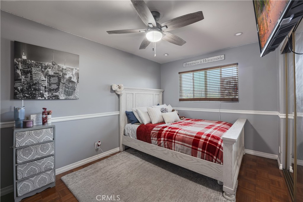 2203 Homewood Avenue Simi Valley, CA 93063 - Photo 23 of 37 a bedroom with a bed and a chandelier