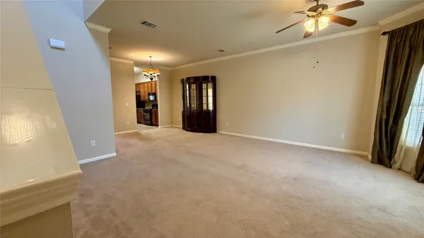 a view of a livingroom with a ceiling fan and window