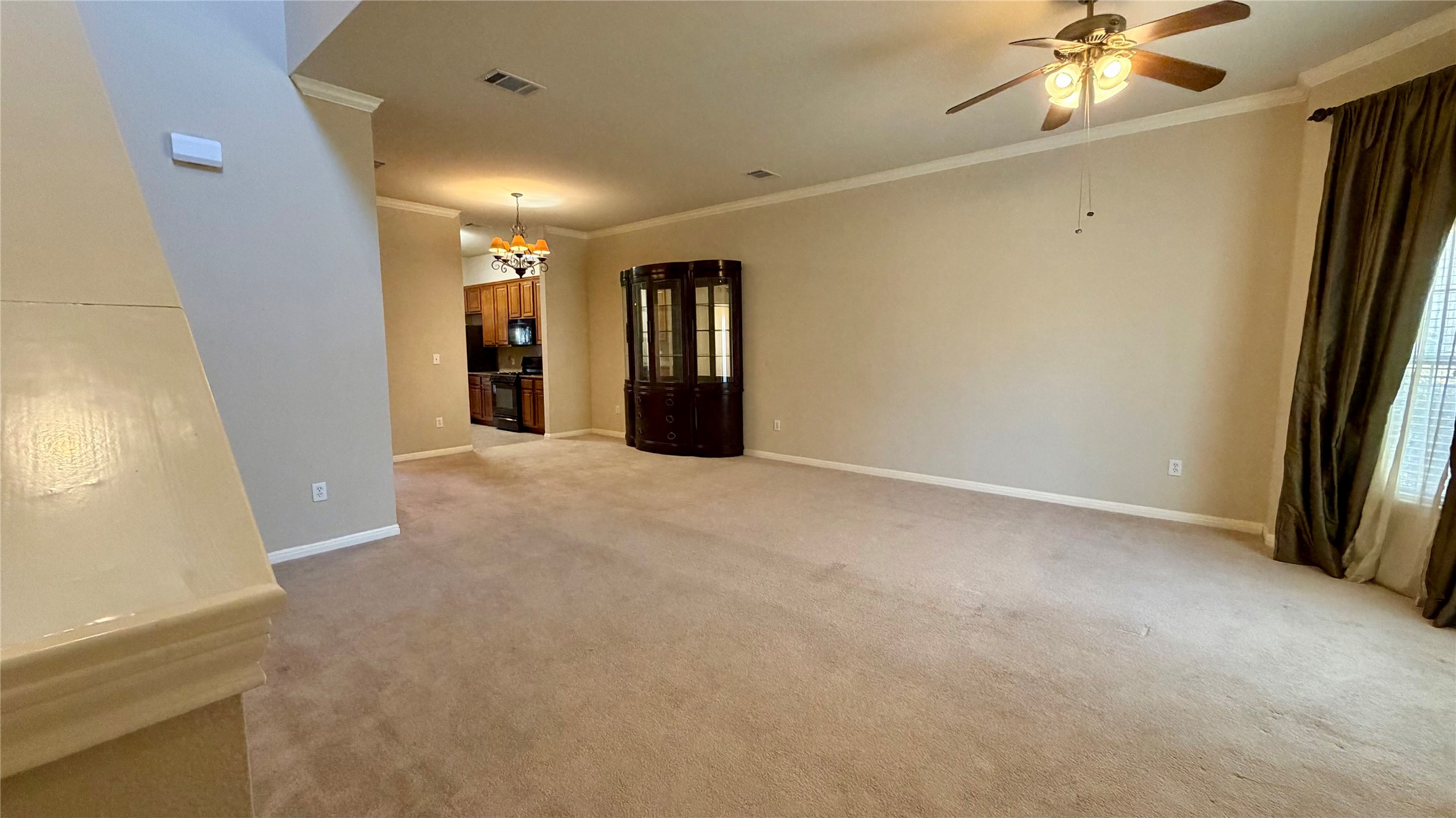 a view of a livingroom with a ceiling fan and window