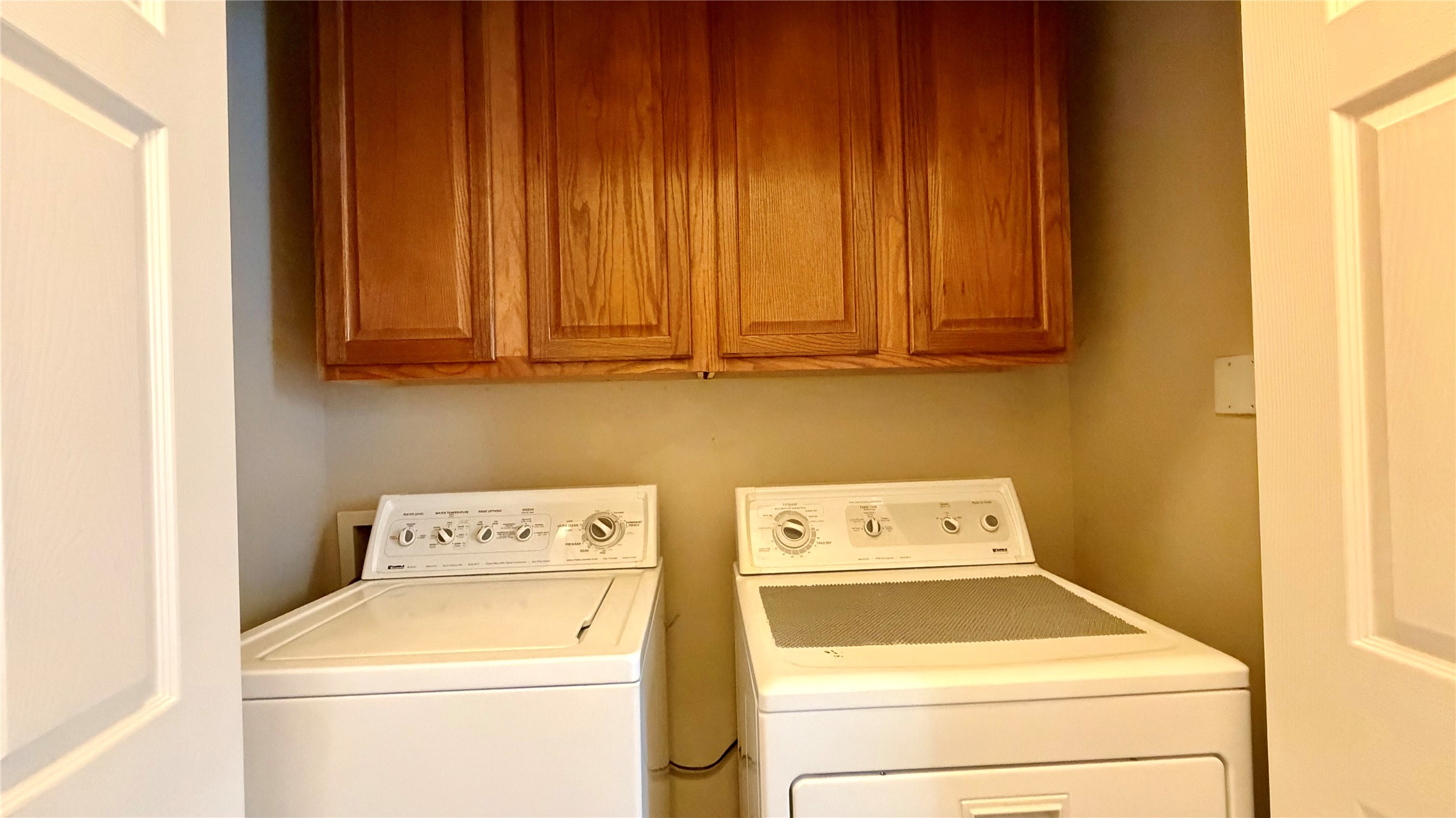 5515 Davis Lane, Unit 82 Austin, TX 78749 - Photo 11 of 28 Laundry area featuring cabinet space and washing machine and clothes dryer.