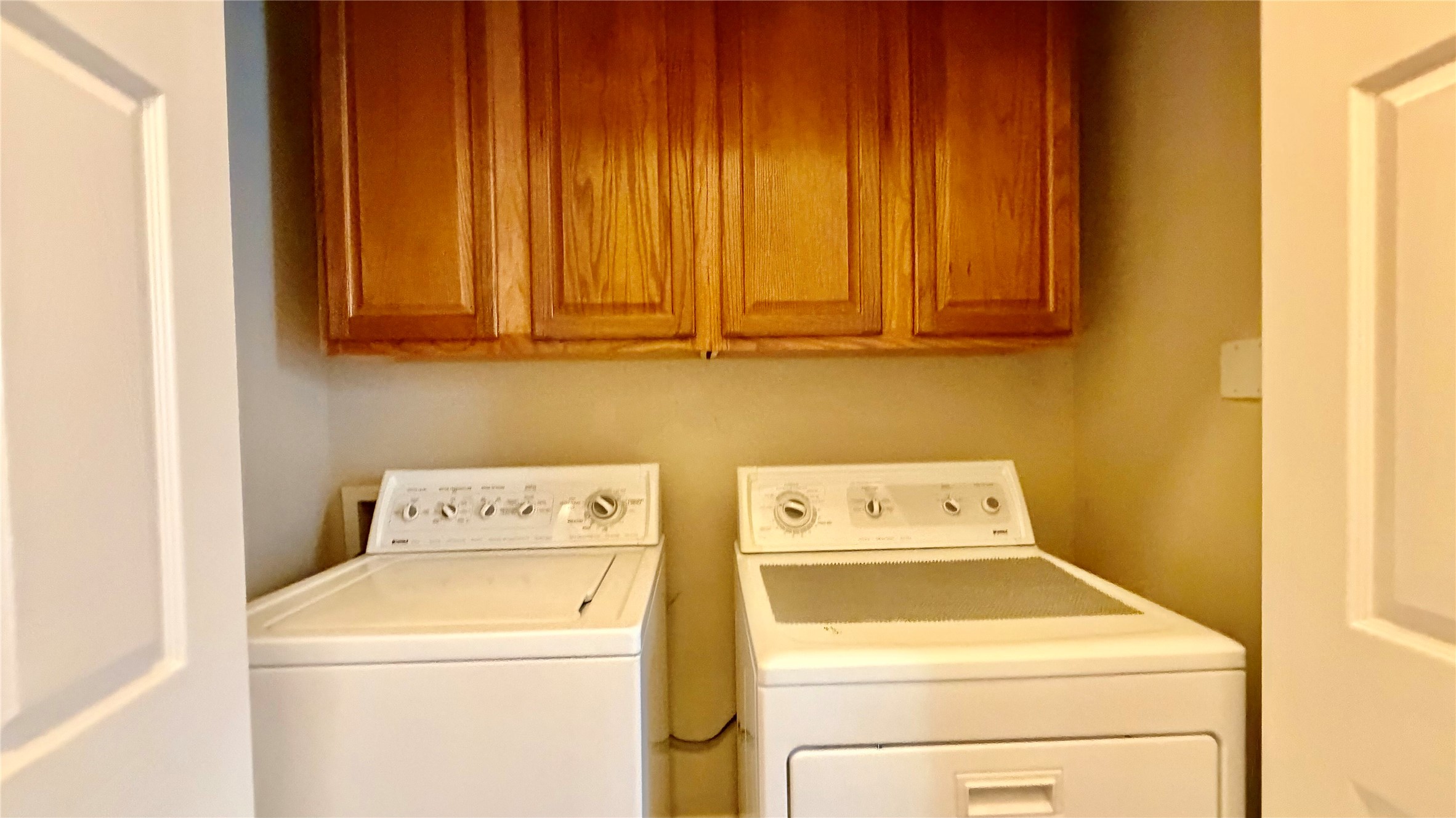 5515 Davis Lane, Unit 82 Austin, TX 78749 - Photo 12 of 28 Laundry area featuring cabinet space and washing machine and clothes dryer.