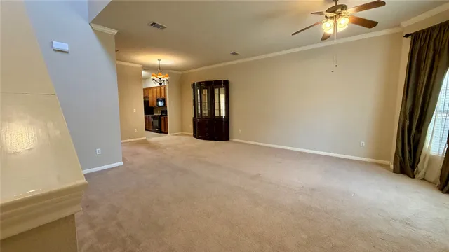 a view of a livingroom with a ceiling fan and window