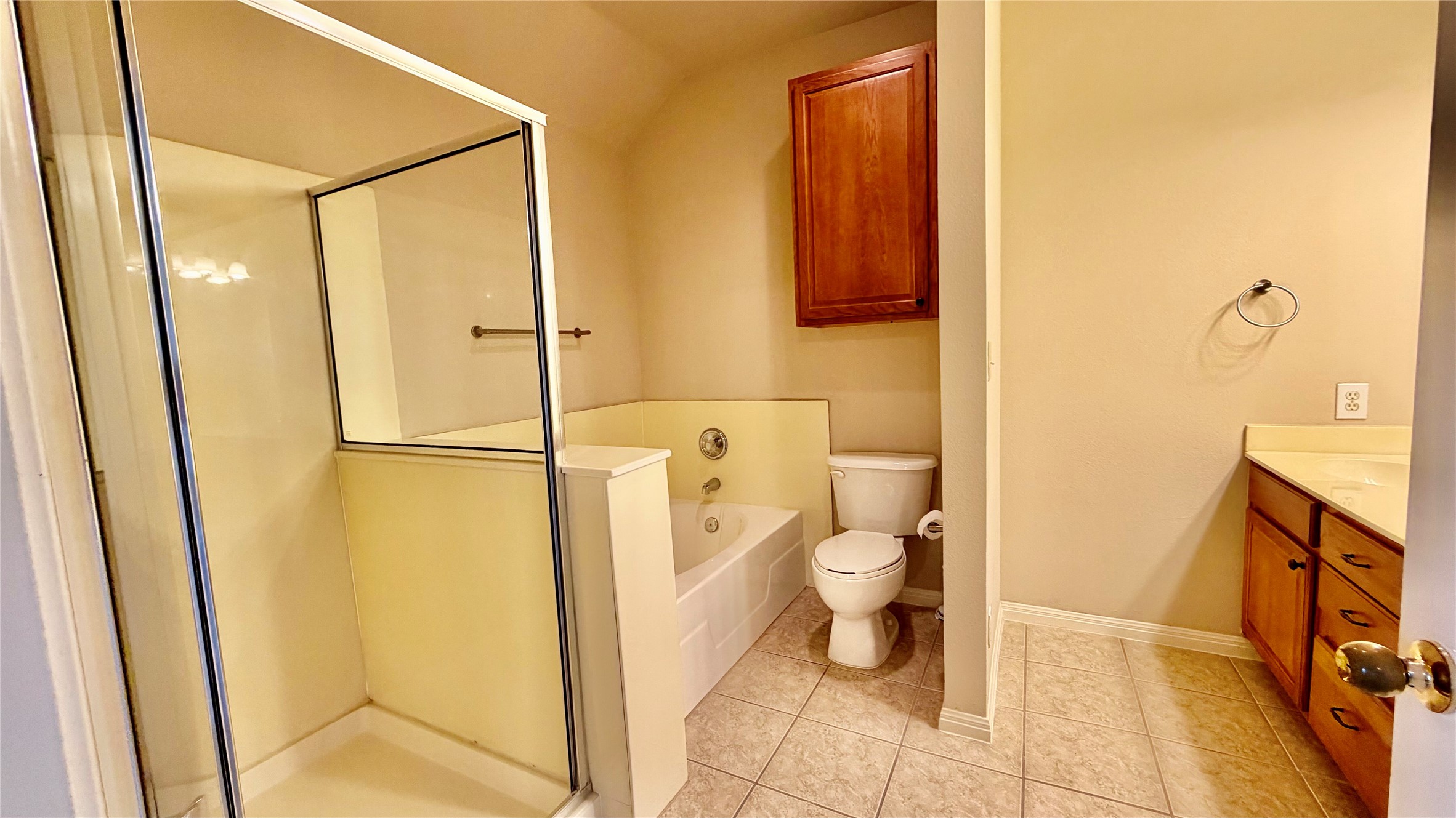 5515 Davis Lane, Unit 82 Austin, TX 78749 - Photo 24 of 28 Primary Bathroom featuring a garden tub, a separate stall shower, vanity, and light tile patterned floors.