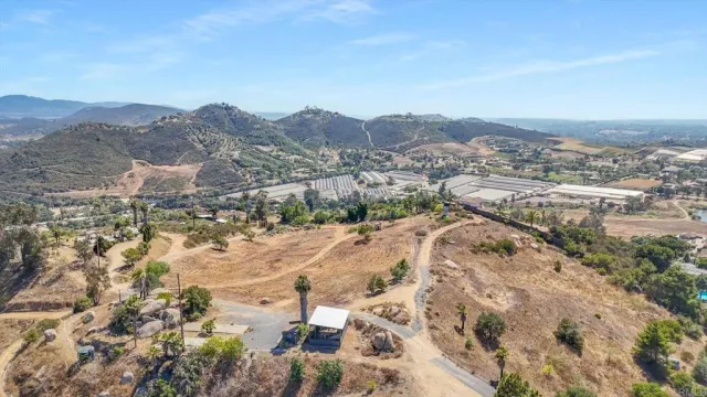 an aerial view of residential house and mountains in the background