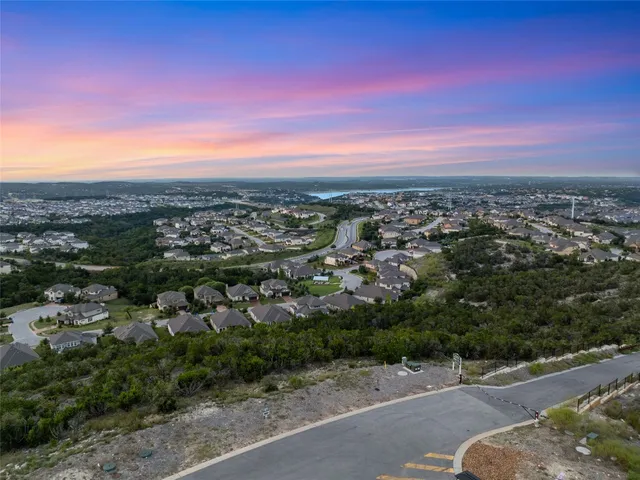 a view of a city with lush green forest